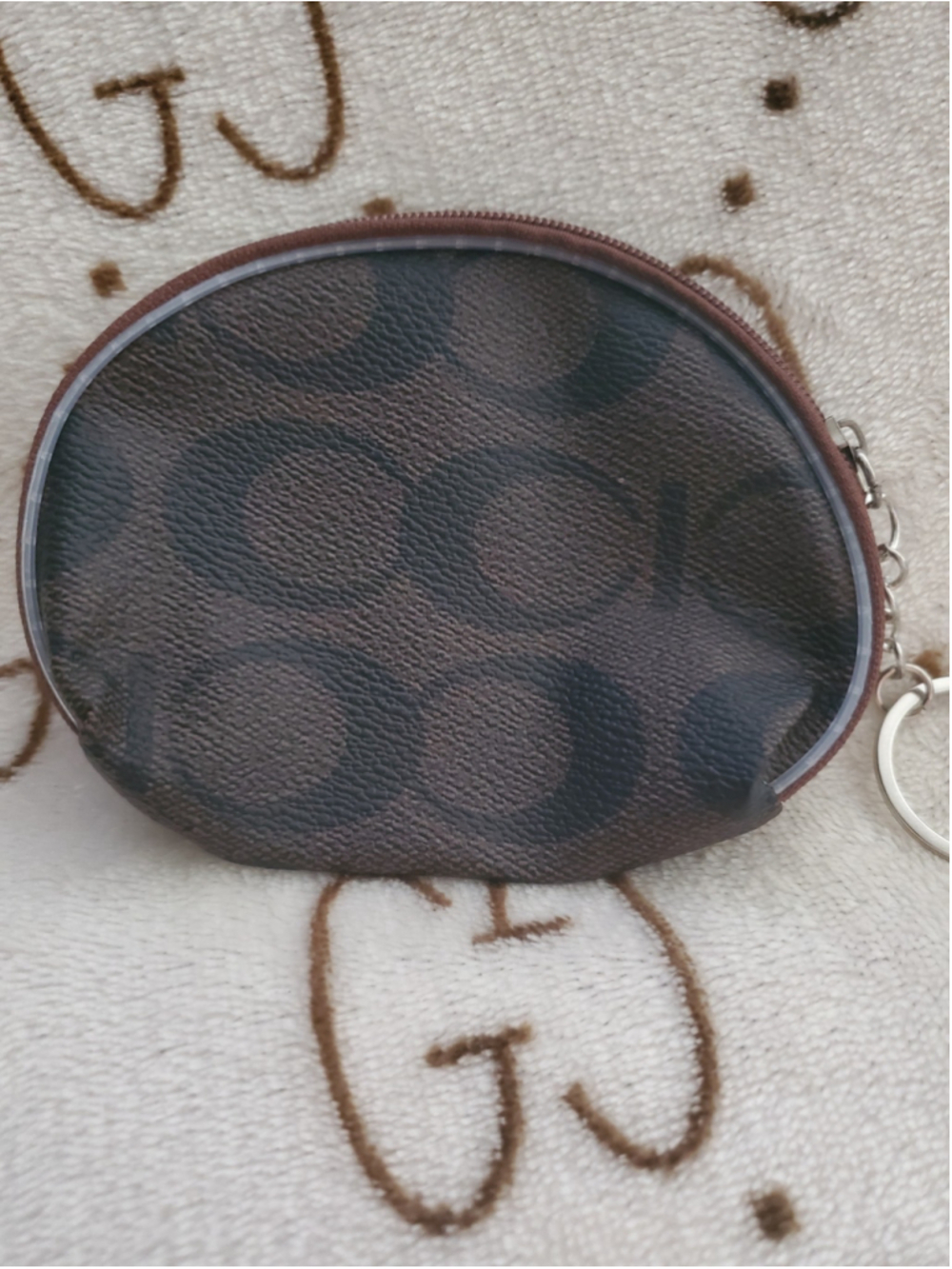 Oval-shaped Brown and Black Coach styled coin purse